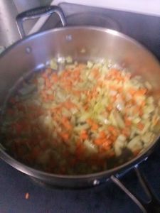 Sauteing the carrots, onions and peas.